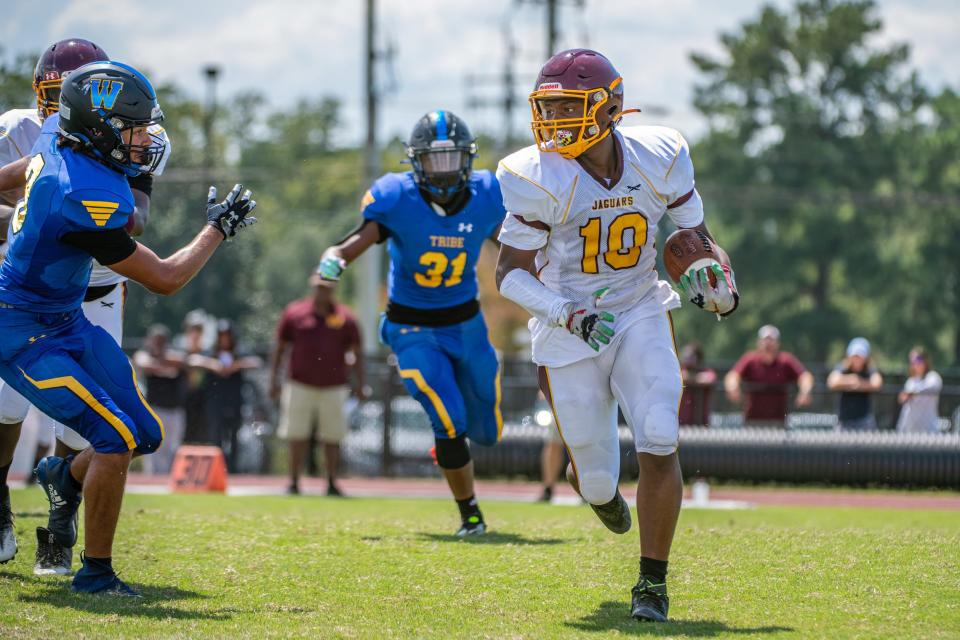 Washington High's Wayne Spence tries to turn up the field for some yardage in their Bayside matchup game against Wi-Hi on Saturday, Sept. 3, 2022.