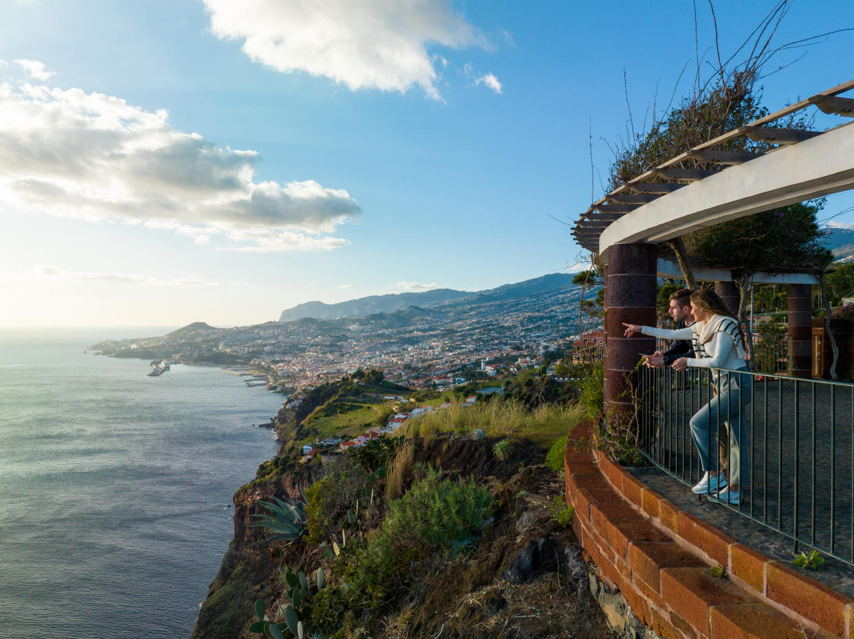 A couple looks out over the landscape of Madeira.