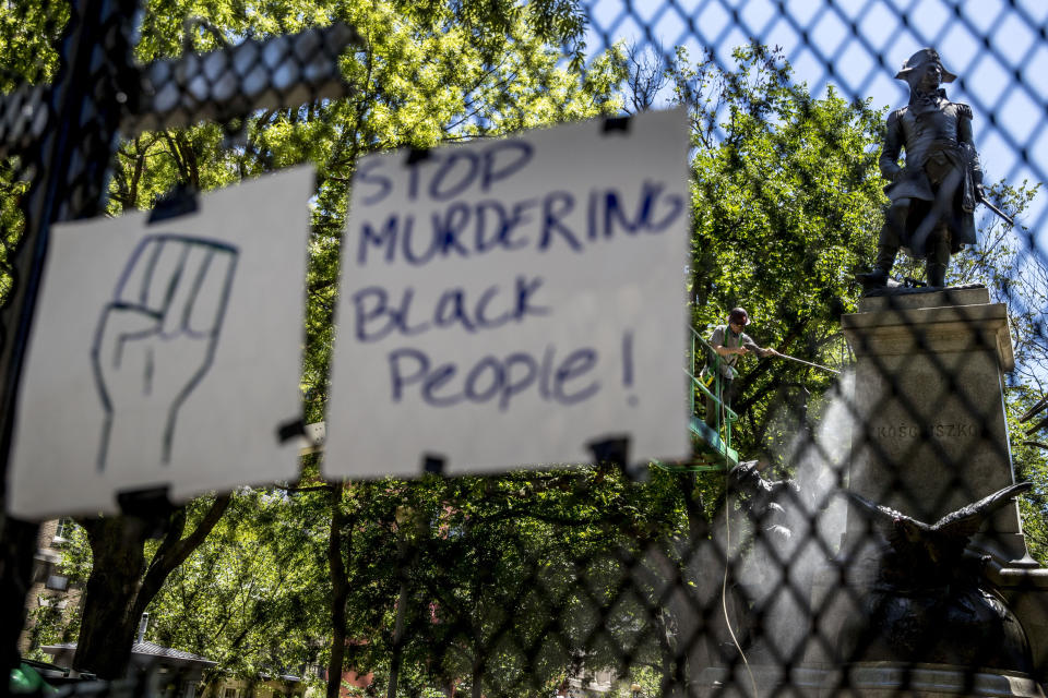 A worker power washes graffiti off of a statue in Lafayette Park, Monday, June 8, 2020, near the White House in Washington, after days of protest over the death of George Floyd, a black man who was in police custody in Minneapolis. Floyd died after being restrained by Minneapolis police officers. (AP Photo/Andrew Harnik)