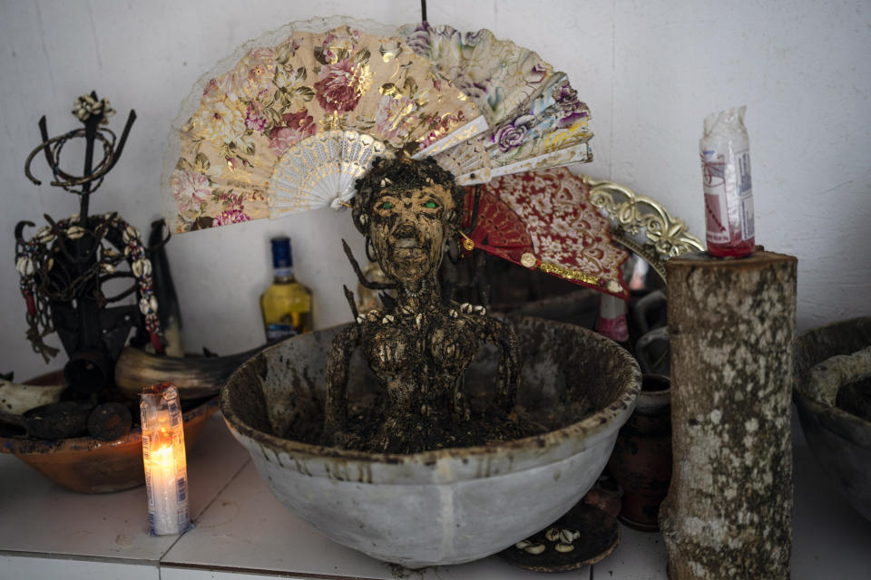 Figures adorn an altar inside the temple of Jaciara Ribeiro, a priestess of the Afro Brazilian faith Candomble, in Salvador, Brazil, Wednesday, Sept. 14, 2022. Ribeiro, who is known as Mother Jaciara of Oxum, says members of her temple have been insulted when walking past a dune where evangelicals congregate or had Bibles brandished at them. (AP Photo/Rodrigo Abd)