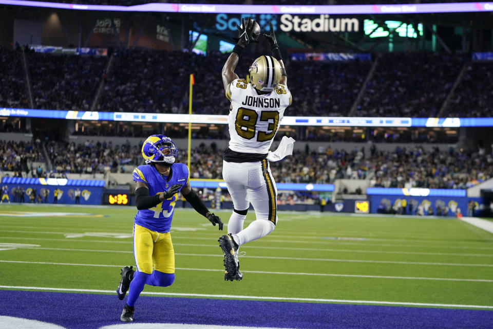 New Orleans Saints tight end Juwan Johnson (83) catches a touchdown over Los Angeles Rams safety John Johnson III (43) during the second half of an NFL football game Thursday, Dec. 21, 2023, in Inglewood, Calif. (AP Photo/Ryan Sun)