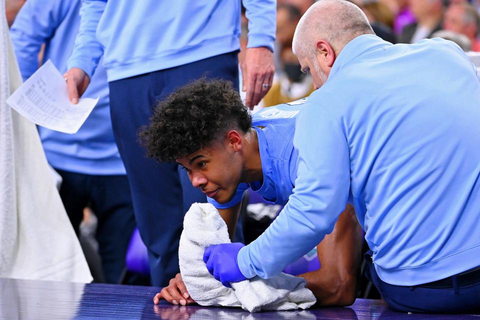 Tar Heels guard Puff Johnson tries to recover after taking a blow to the stomach in the second half.