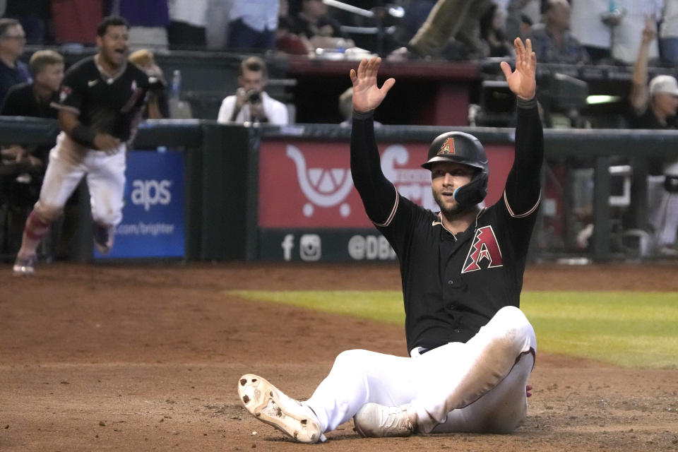 Arizona Diamondbacks' Christian Walker reacts after scoring the winning run against the San Francisco Giants on a double by Lourdes Gurriel Jr. in the ninth inning during a baseball game, Sunday, May 14, 2023, in Phoenix. (AP Photo/Rick Scuteri)