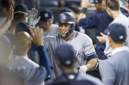 Aug 7, 2018; Chicago, IL, USA; New York Yankees right fielder Giancarlo Stanton (27) celebrates his two run home run during the tenth inning against the Chicago White Sox at Guaranteed Rate Field. Patrick Gorski-USA TODAY Sports