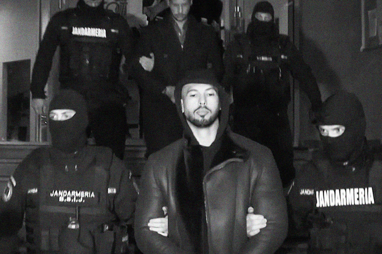 Andrew Tate led away by police in Romania, on Dec. 29, 2022.  (Observator Antena 1  / via AP)