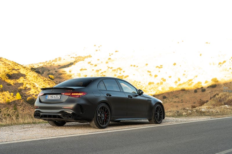 2023 mercedes-amg c 63 s e-performance in matte black photographed on the side of a mountain road in spain