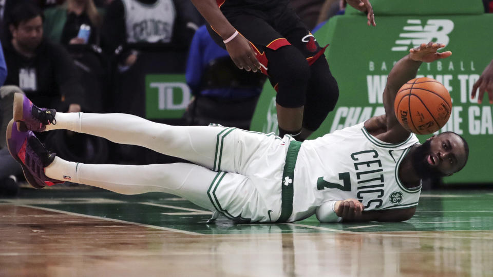 Boston Celtics guard Jaylen Brown (7) dives the ball during the second half of an NBA basketball game against the Miami Heat in Boston, Wednesday, Dec. 4, 2019. (AP Photo/Charles Krupa)