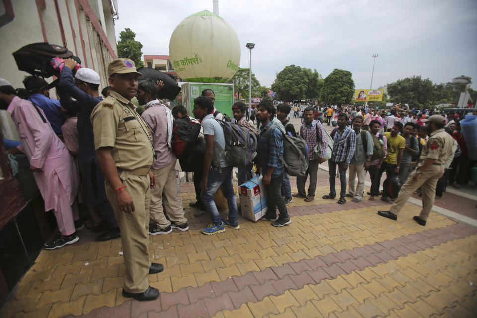 Indian migrant laborers carry their luggage and prepare to leave the region, at a railway station in Jammu, India, Wednesday, Aug. 7, 2019. Indian lawmakers passed a bill Tuesday that strips statehood from the Indian-administered portion of Muslim-majority Kashmir, which remains under an indefinite security lockdown, actions that archrival Pakistan warned could lead to war. (AP Photo/Channi Anand)