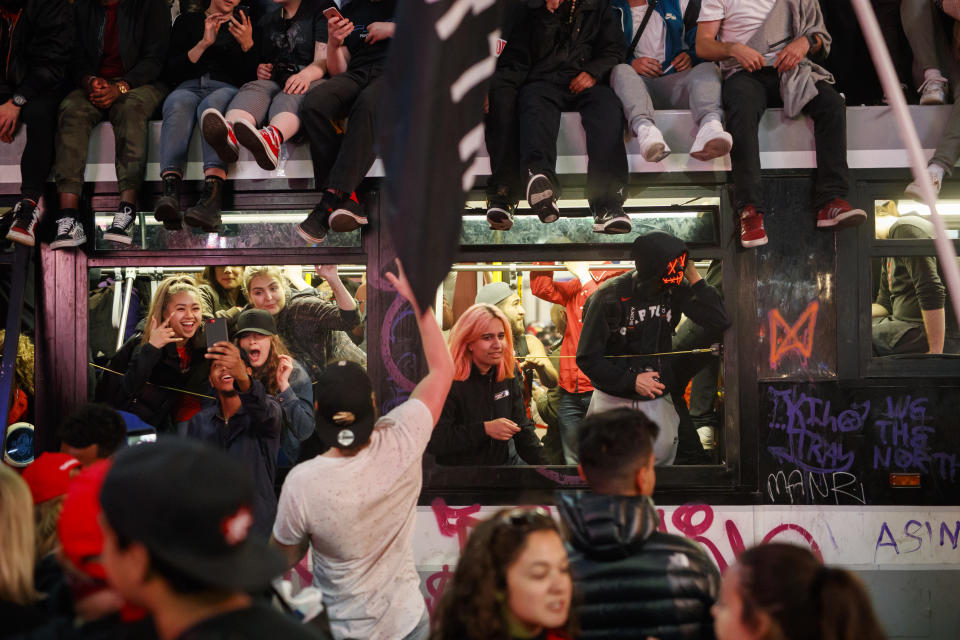 TORONTO, ON - JUNE 14: Toronto Raptors fans celebrate atop and inside a bus on Yonge St. after the team beat the Golden State Warriors in Game Six of the NBA Finals, on June 14, 2019 in Toronto, Canada. (Photo by Cole Burston/Getty Images)