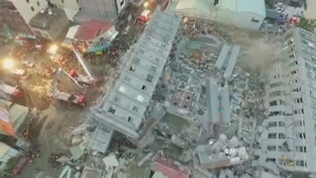 Rescue workers search for survivors at a 17-storey building which collapsed during an earthquake in Tainan, southern Taiwan, in this still image taken from video shot on February 6, 2016. REUTERS/CTI via Reuters TV
