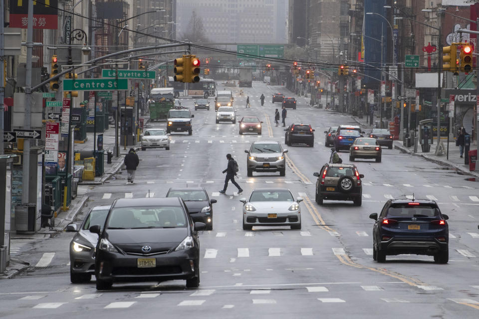 Pedestrians and traffic are seen on Canal Street Sunday, March 29, 2020, in New York. (AP Photo/Mary Altaffer)