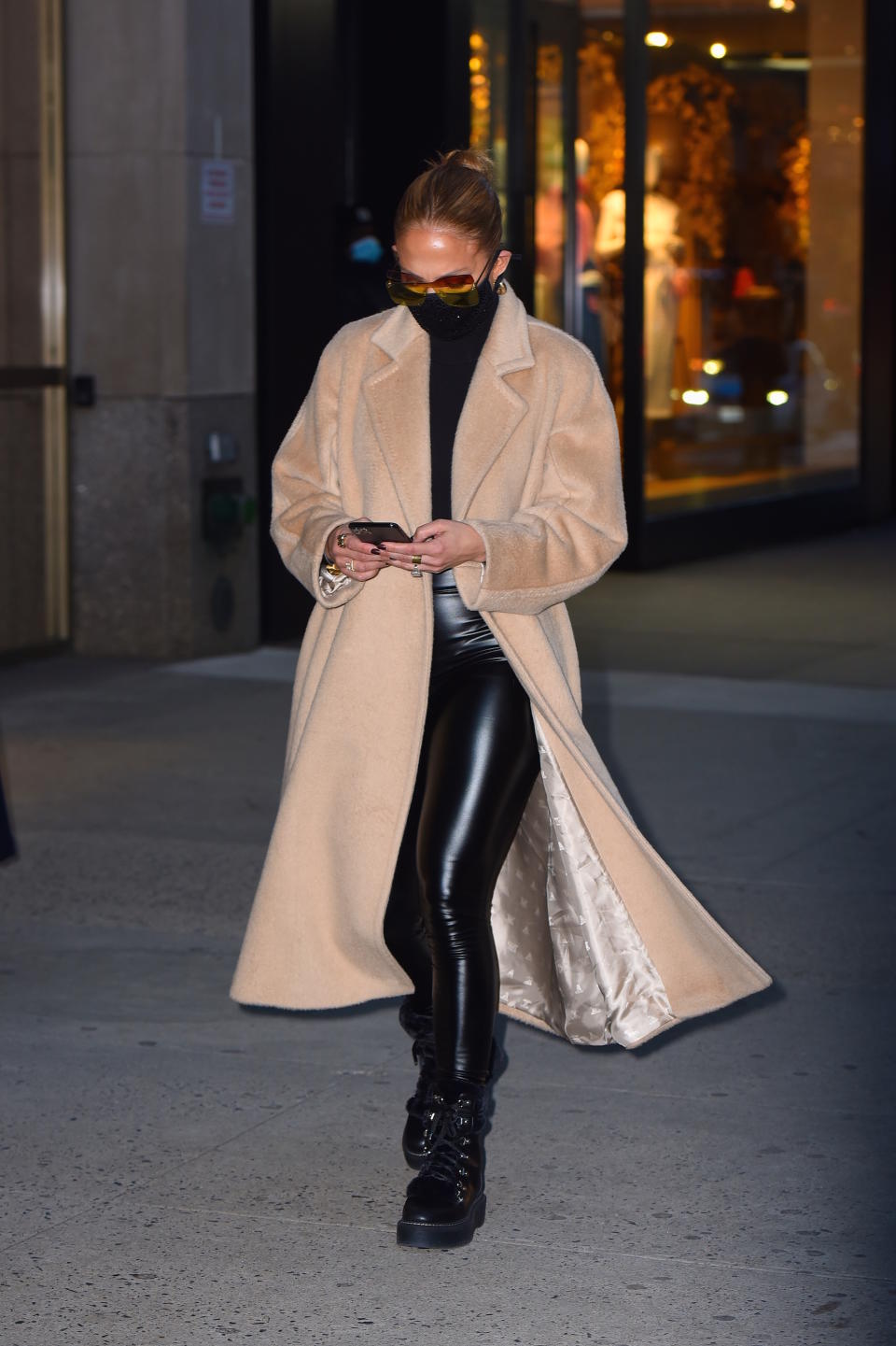 jennifer lopez wearing camel coat, black boots, black leggings and black sweat, Jennifer Lopez wearing leather leggings while out shopping in New York City. (Photo by Robert Kamau/GC Images)