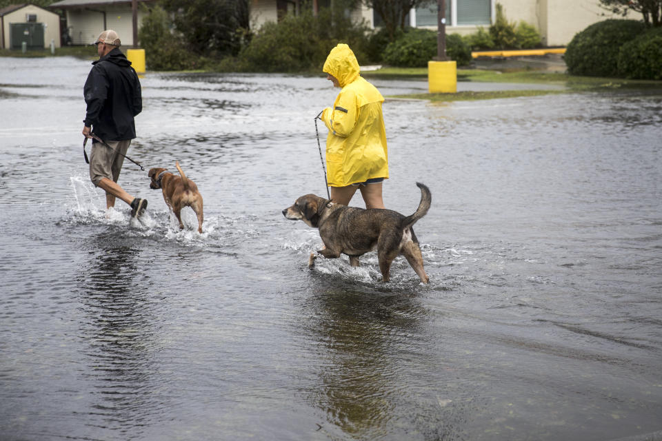 Pedestrians cross a flooded parking lot after Hurricane Florence in Wilmington, North Carolina, U.S., on Saturday, Sept. 15, 2018.&nbsp;