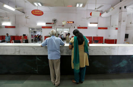 Customers wait to deposit their money inside a post office in New Delhi, India, October 21, 2016. Picture taken October 21, 2016. REUTERS/Adnan Abidi