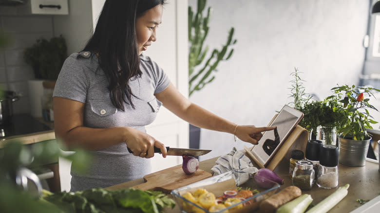 young Asian woman prepping vegetables