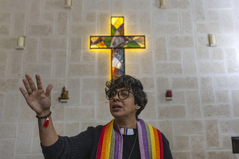 La reverenda Elaine Saralegui, con una estola y su alzacuellos con colores del arcoirís, dirige un servicio en la Iglesia de la Comunidad Metropolitana, una casa de oración inclusiva LGBTQ+, en Matanzas, Cuba, el 2 de febrero de 2024. (AP Foto/Ramon Espinosa)