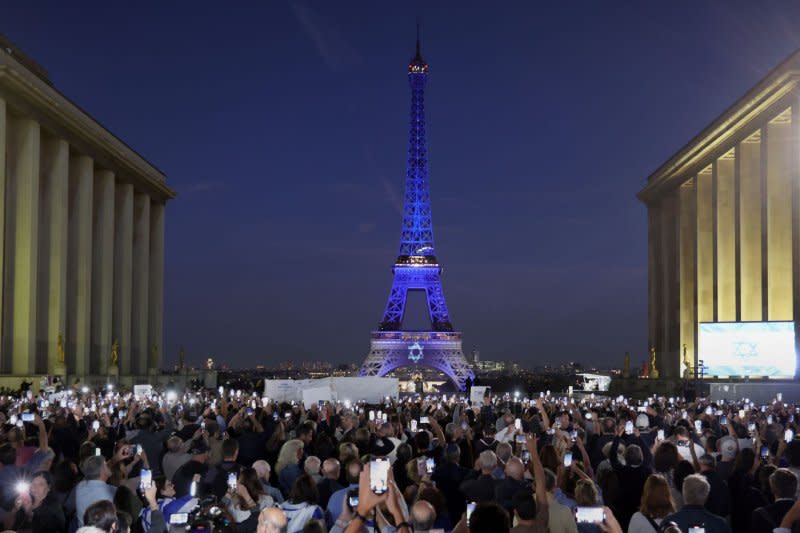 The Eiffel Tower is illuminated with the colors of the Israeli flat and its Star of David in support of the Jewish State in Paris, on Monday. France has said that two of its nationals have been killed in Israel. Photo by Maya Vidon-White/UPI