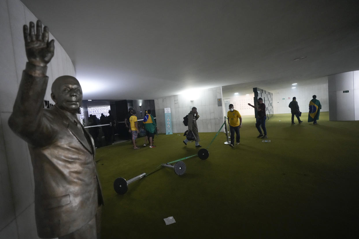 Protesters, supporters of Brazil's former President Jair Bolsonaro, storm the the National Congress building in Brasilia, Brazil, Sunday, Jan. 8, 2023. (AP Photo/Eraldo Peres)