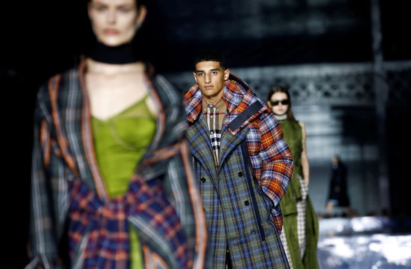 FILE PHOTO: Models present creations during the Burberry catwalk show at London Fashion Week in London