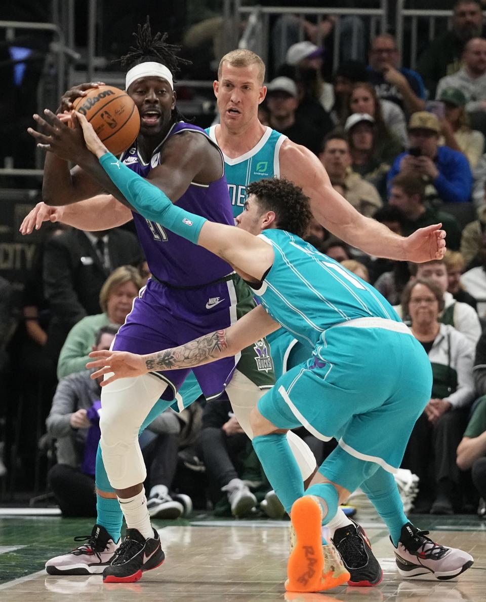 Bucks guard Jrue Holiday is fouled by Hornets guard LaMelo Ball during the first half Friday night.