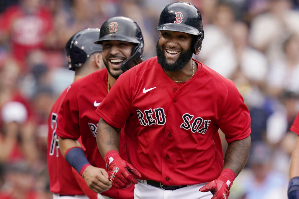 Boston Red Sox's Danny Santana, right, laughs with Marwin Gonzalez, left, as they run back to the dugout after Santana's three-run homer against the Kansas City Royals in the fourth inning of a baseball game at Fenway Park, Thursday, July 1, 2021, in Boston. (AP Photo/Elise Amendola)