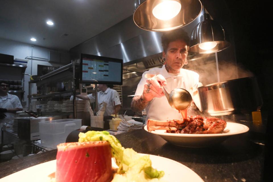 Chef Paul Sellas preps yellowfin filet and a lamb shank at Prime and Pint in Columbia, Tenn. on April 19, 2024.