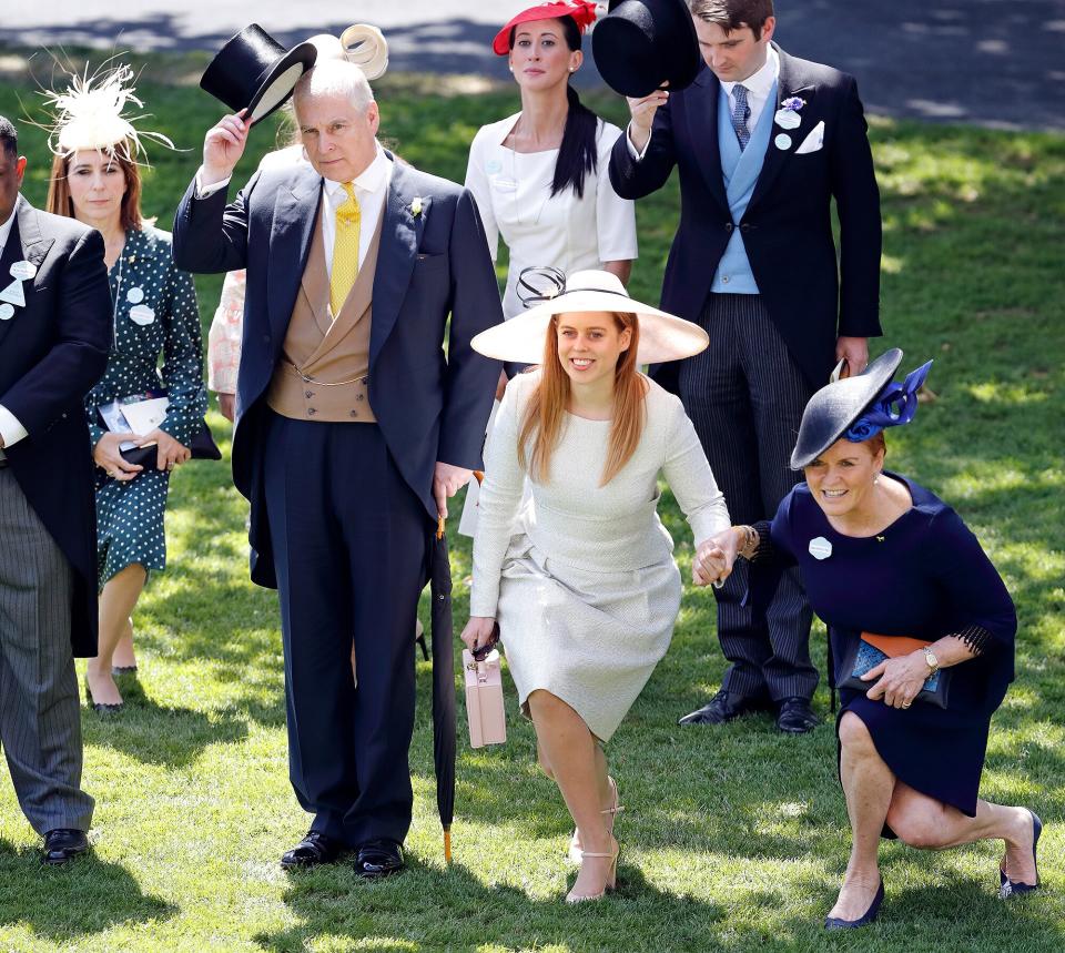 Prince Andrew, Duke of York doffs his top hat whilst Princess Beatrice, Sarah, Duchess of York and Amanda Thirsk