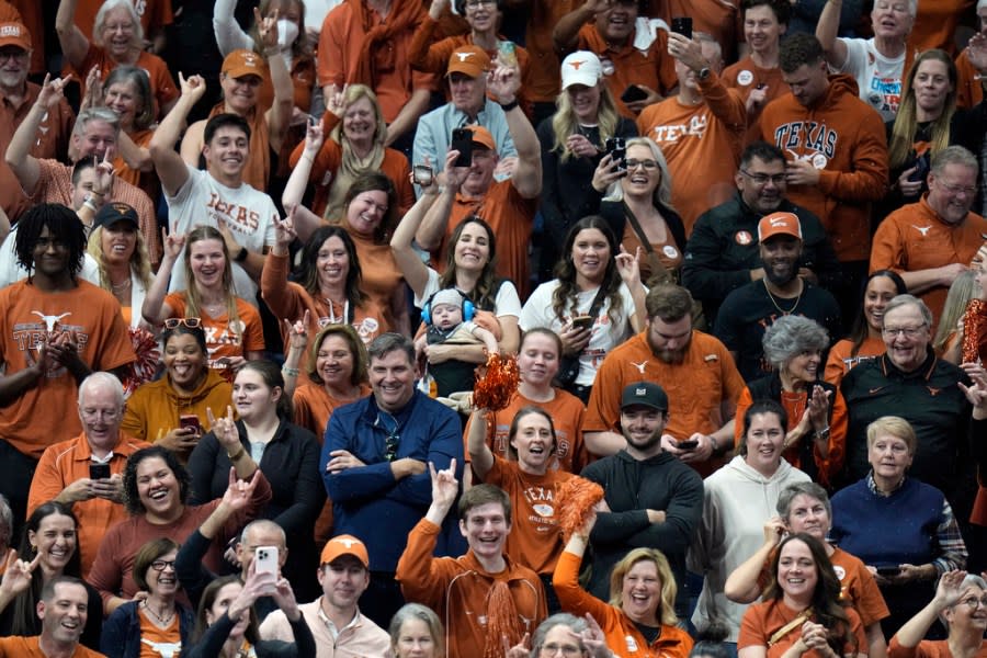 Texas fans celebrate after their team defeated Nebraska to win during the championship match in the NCAA Division I women’s college volleyball tournament Sunday, Dec. 17, 2023, in Tampa, Fla. (AP Photo/Chris O’Meara)