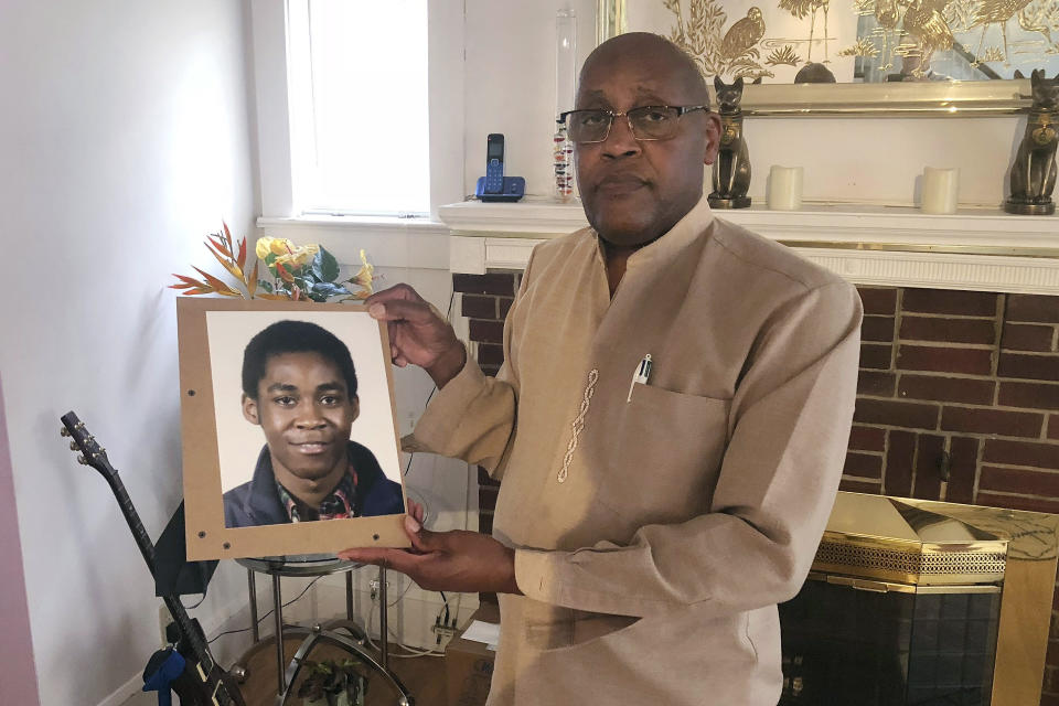 FILE - In this Sept. 5, 2018 file photo, Dia Khafra, father of Askia Khafra, holds a photo of his son in his Silver Springs, Md., home. Maryland's highest court on Friday, Jan. 28, 2022, upheld Daniel Beckwitt's conviction on a charge of involuntary manslaughter in the fiery death of Askia Khafra, who was helping him dig tunnels for a nuclear bunker under a home. (AP Photo/Michael Kunzelman, File)