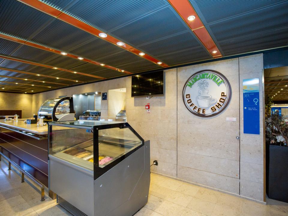 An empty coffee stand with ice cream in a freezer.