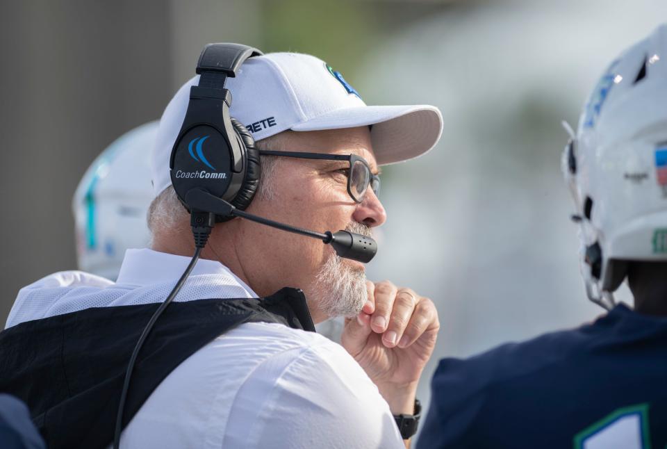 Head coach Pete Shinnick communicates with his assistants during the Shorter vs UWF football game at Blue Wahoos Stadium in Pensacola on Saturday, Oct. 23, 2021.