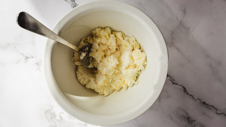 Mixing cheese in bowl