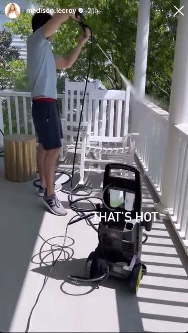 Brett Randle power washing the home porch.