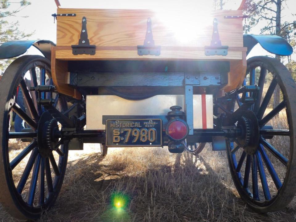 The Grimm brothers' 1907 International Harvester high-wheeler auto buggy has a seat in the front and a wooden bed, similar to a pickup truck, in the back.