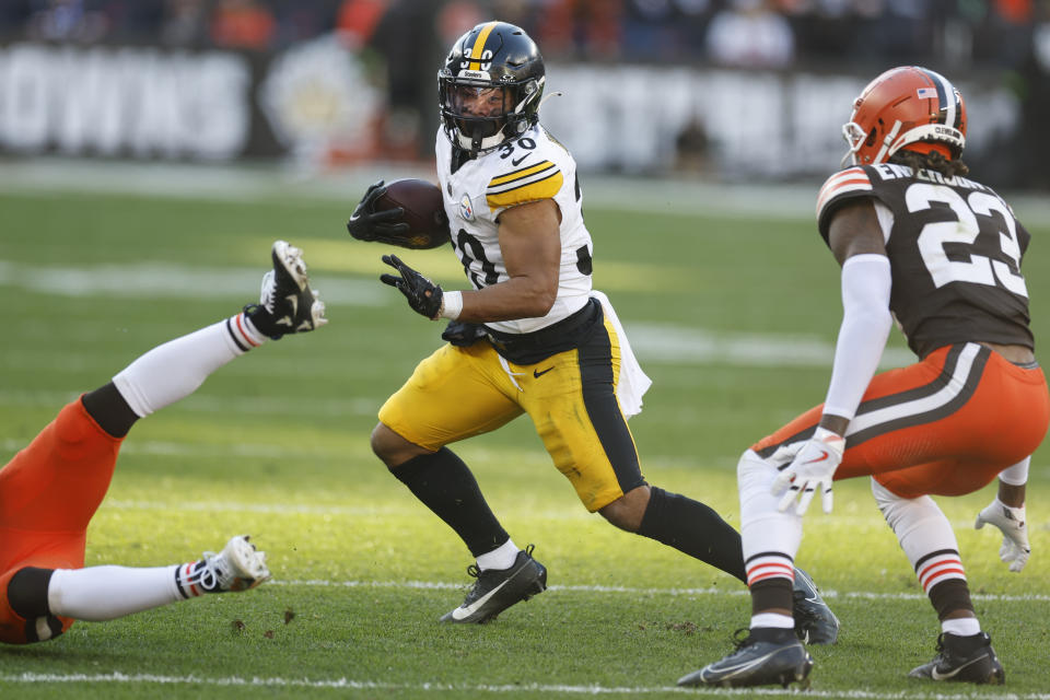 Pittsburgh Steelers running back Jaylen Warren (30) runs near Cleveland Browns cornerback Martin Emerson Jr. (23) during the second half of an NFL football game, Sunday, Nov. 19, 2023, in Cleveland. (AP Photo/Ron Schwane)