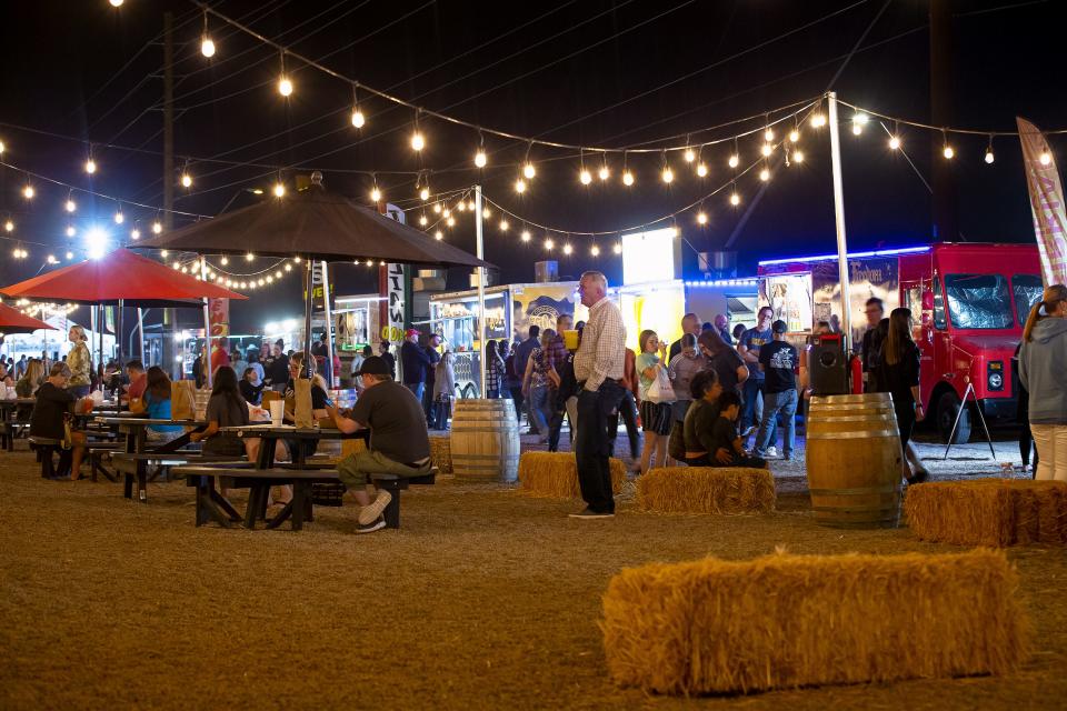 Picnic tables and hay bales serve as dining areas at the Power Food Park in Mesa on Nov. 20, 2021.