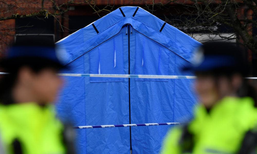 Police officers stand guard in front of a forensics tent in a cordoned off area in the centre of Salisbury.