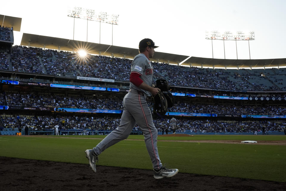 Cincinnati Reds left fielder Jacob Hurtubise (26) takes the field during the second inning of a baseball game against the Los Angeles Dodgers in Los Angeles, Saturday, May 18, 2024. (AP Photo/Ashley Landis)