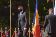 Polish President Andrzej Duda, left, walks with Romanian President Klaus Iohannis during the welcoming ceremony at the Cotroceni presidential palace in Bucharest, Romania, Monday, May 10, 2021. (AP Photo/Alexandru Dobre)