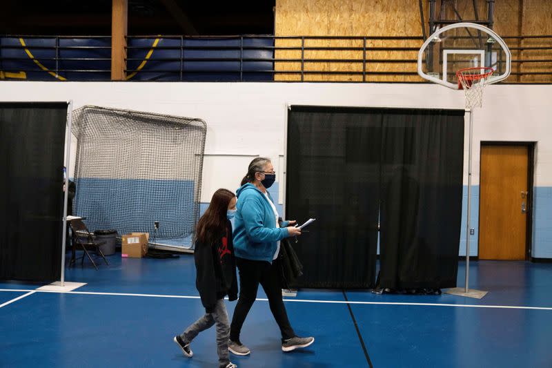 People from rural communities get their coronavirus disease (COVID-19) vaccinations at Menominee Indian High School in Menominee, Wisconsin