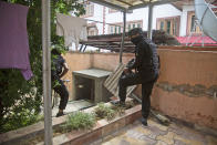 Members of special Operations Group (SOG) of Jammu and Kashmir police examine at the site of an attack on policemen on the outskirts of Srinagar, Indian controlled Kashmir, Friday, Aug. 14, 2020. Anti-India rebels in Indian-controlled Kashmir Friday attacked a police party in the disputed region's main city, killing two police officials and injuring another, police said. (AP Photo/Mukhtar Khan)