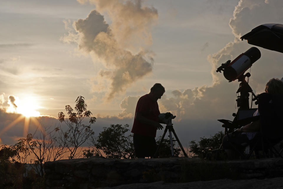 Astrophotographer Johnny Horne sets up his equipment to photograph Comet NEOWISE at Grandfather Mountain in Linville, N.C., Friday, July 17, 2020. (AP Photo/Gerry Broome)