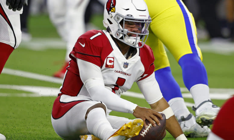 Cardinals quarterback Kyler Murray sitting on the ground after getting sacked.