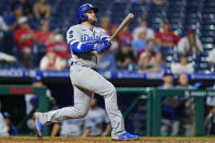 Los Angeles Dodgers' Max Muncy follows through after hitting a home run off Philadelphia Phillies relief pitcher Mauricio Llovera during the ninth inning of a baseball game, early Wednesday morning, Aug. 11, 2021, in Philadelphia. (AP Photo/Matt Slocum)