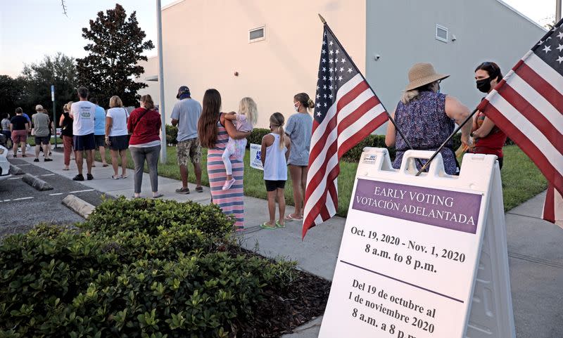 People line up to cast ballots during early voting session in Celebration, Florida