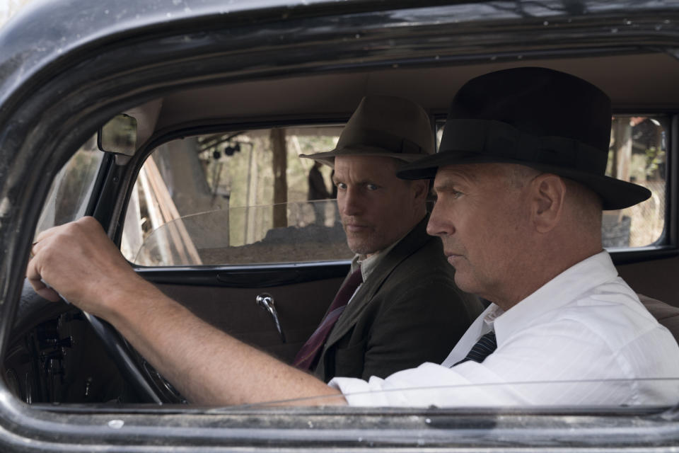 Kevin Costner and Woody Harrelson in 1930's era clothing sitting in a period car.