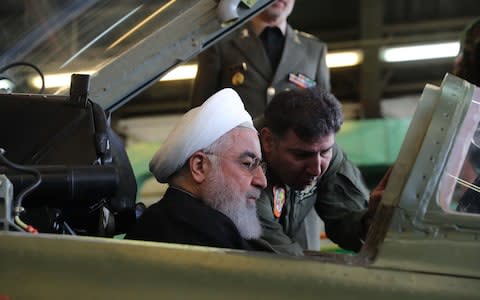 President Hassan Rouhani sits in the cockpit after the jet was unveiled  - Credit:  AFP