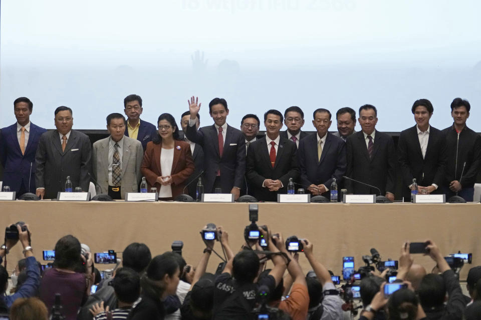 Leader of Move Forward Party Pita Limjaroenrat, center, waves during a press conference with other seven party leaders, in Bangkok, Thailand, Thursday, May 18, 2023. Thailand's election winner Move Forward Party on Thursday announced an 8-party coalition that its leader declared will become a "democratic government of the people. (AP Photo/Sakchai Lalit)