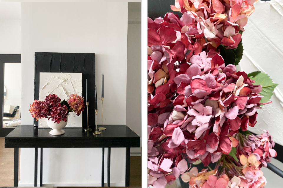 a table with flowers and a picture frame