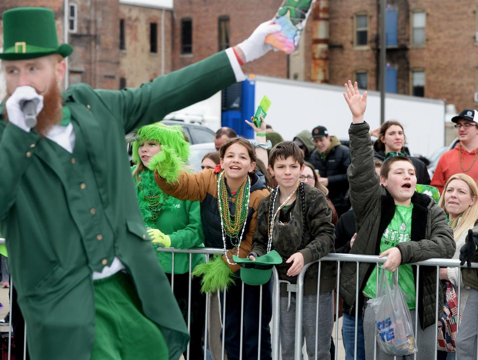 Parade watchers cheer along Fifth Street during the St. Patrick's Day Parade on Match 11, 2023.
